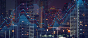 City skyline at night with illuminated high-rise buildings, overlaid with abstract financial graphs including bar charts and line graphs, representing data analytics, market trends or economic activity.