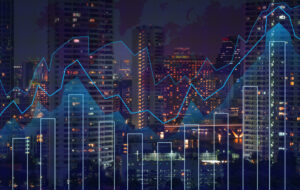 City skyline at night with illuminated high-rise buildings, overlaid with abstract financial graphs including bar charts and line graphs, representing data analytics, market trends or economic activity.