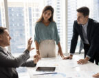 A not-for-profit leadership team in a meeting, preparing for changes in reporting requirements.