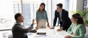 A not-for-profit leadership team in a meeting, preparing for changes in reporting requirements.