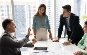 A not-for-profit leadership team in a meeting, preparing for changes in reporting requirements.