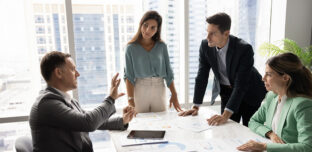 A not-for-profit leadership team in a meeting, preparing for changes in reporting requirements.