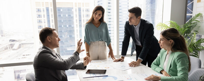 A not-for-profit leadership team in a meeting, preparing for changes in reporting requirements.