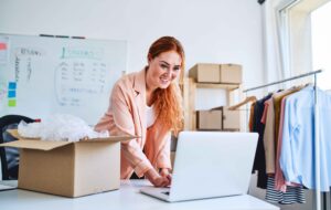 Small business owner reviewing documents on the laptop at the workplace