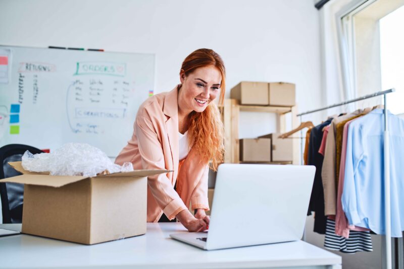 Small business owner reviewing documents on the laptop at the workplace