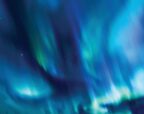 Aurora lights sweeping across a dark night sky in vivid blue, teal and green, with scattered stars visible through the glow.